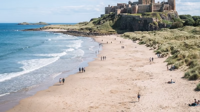 Bamburgh Castle on its crag above a wide empty beach