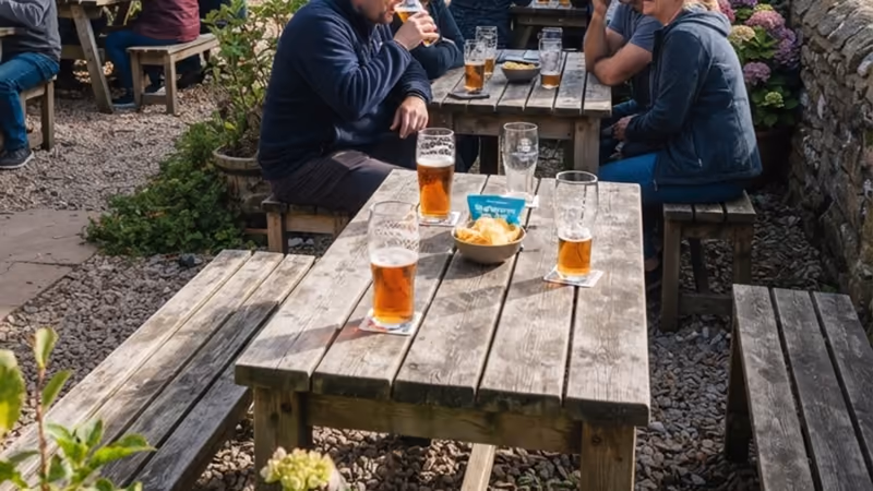 The pub garden at the Craster Arms, tables under the trees