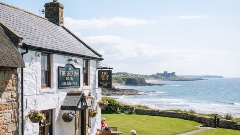 The beer garden of the Ship Inn on the green at Low Newton, the sea beyond