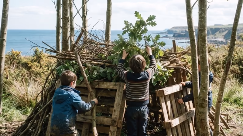 Two children stacking pallets and branches into a den among the trees